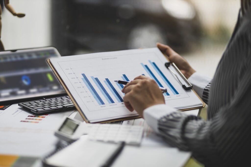 Financial consultant businesswoman analyzing charts in financial report, Analyze investment planning