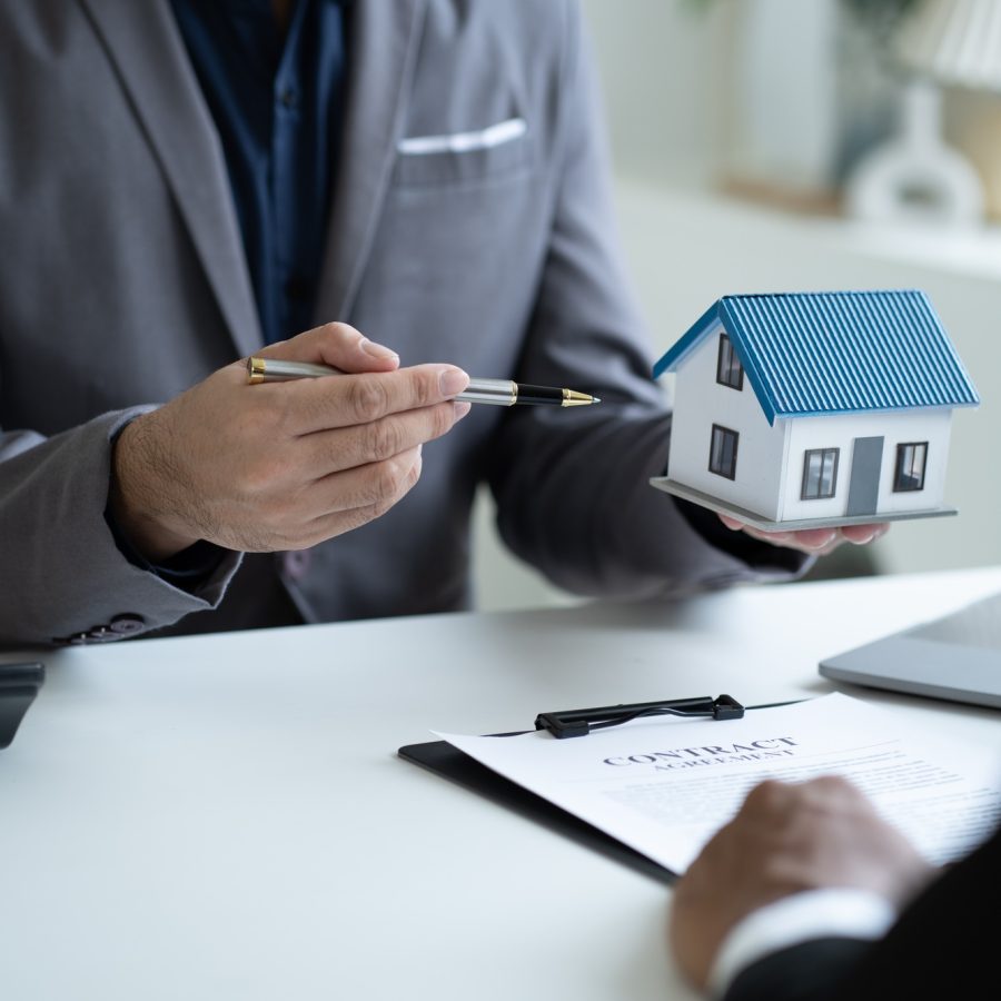 Close up Real Estate agent explain signing agreement for buying house. Bank manager and real estate Close up Real Estate agent explain signing agreement for buying house. Bank manager and real estate